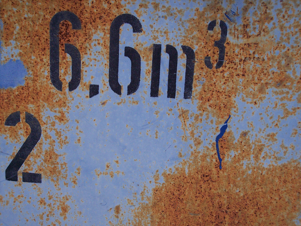 rust, blue paint, black digits on a waste container; photo
